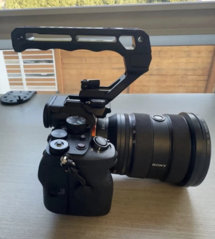sony a7 iv camera, half cage, and top handle (lens not included).there's a littl thumbnail 6